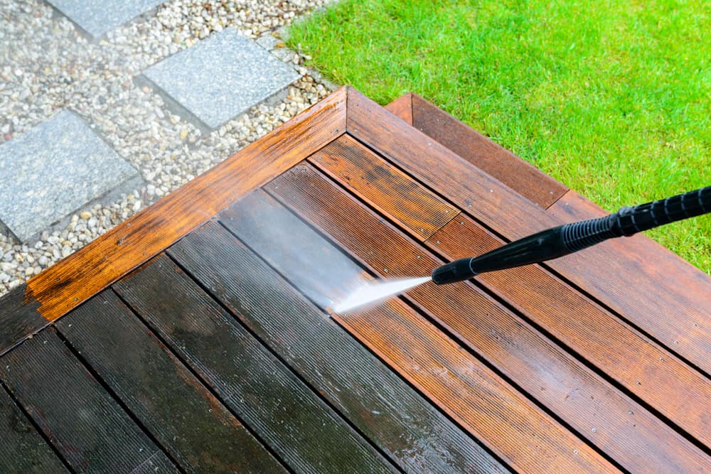 deck surface being pressure washed outside in Bergen county